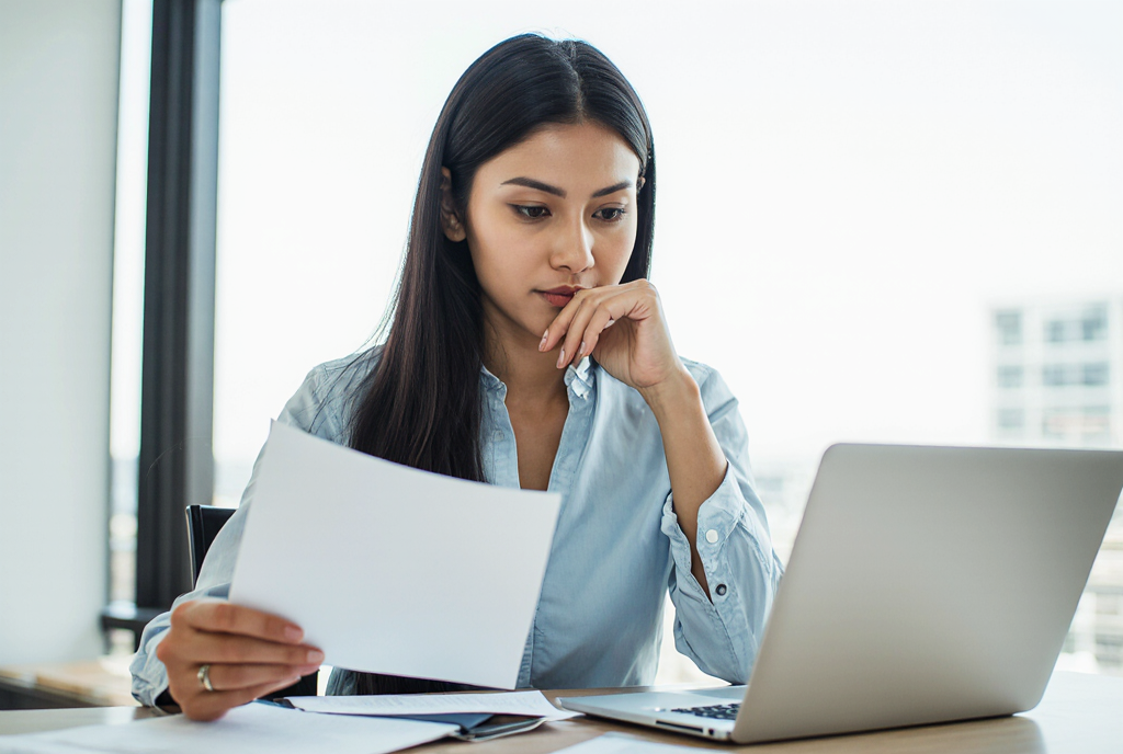 Small business owner comparing information to align services and business direction